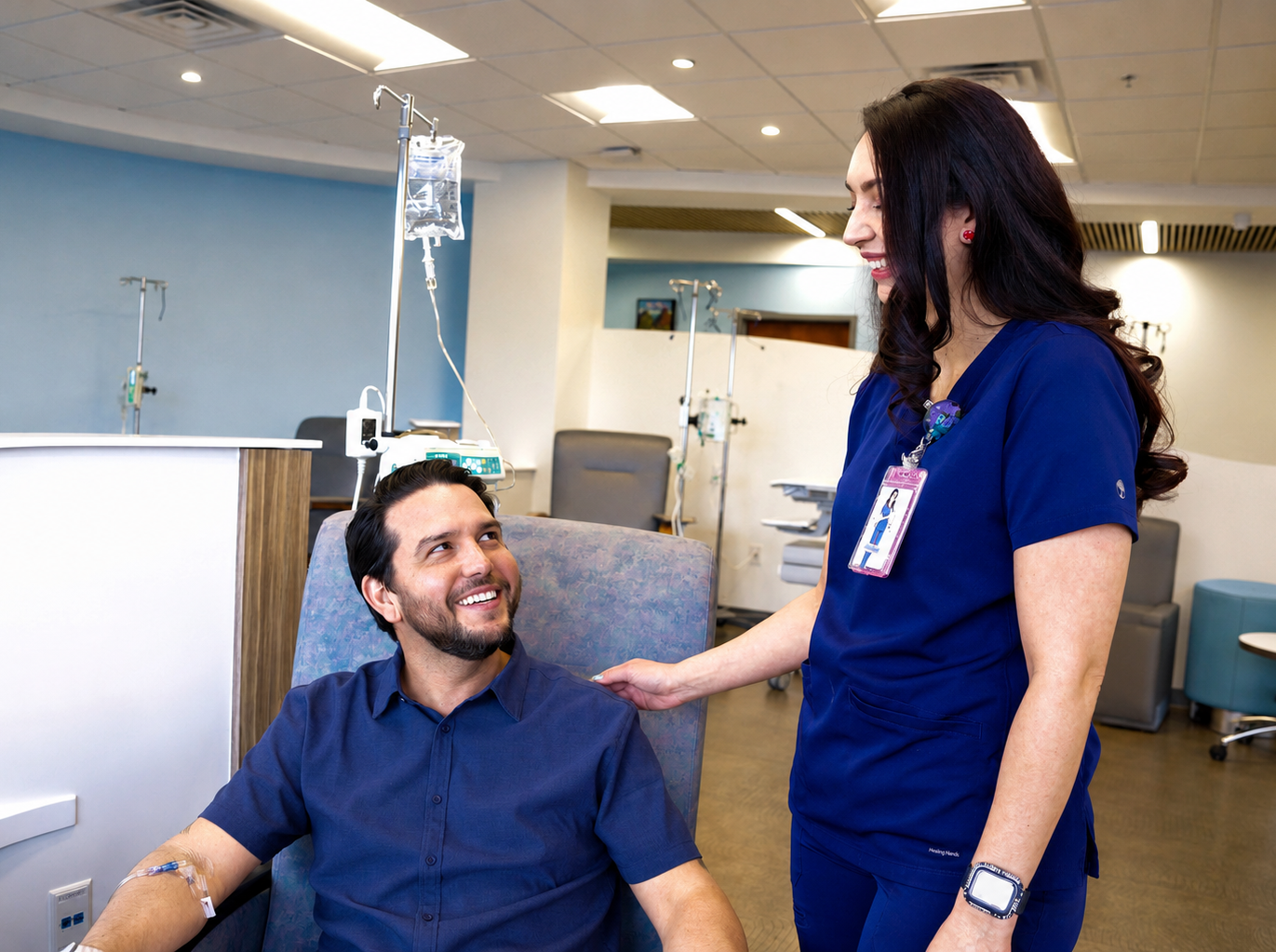 A nurse tending to a patient in an infusion chair